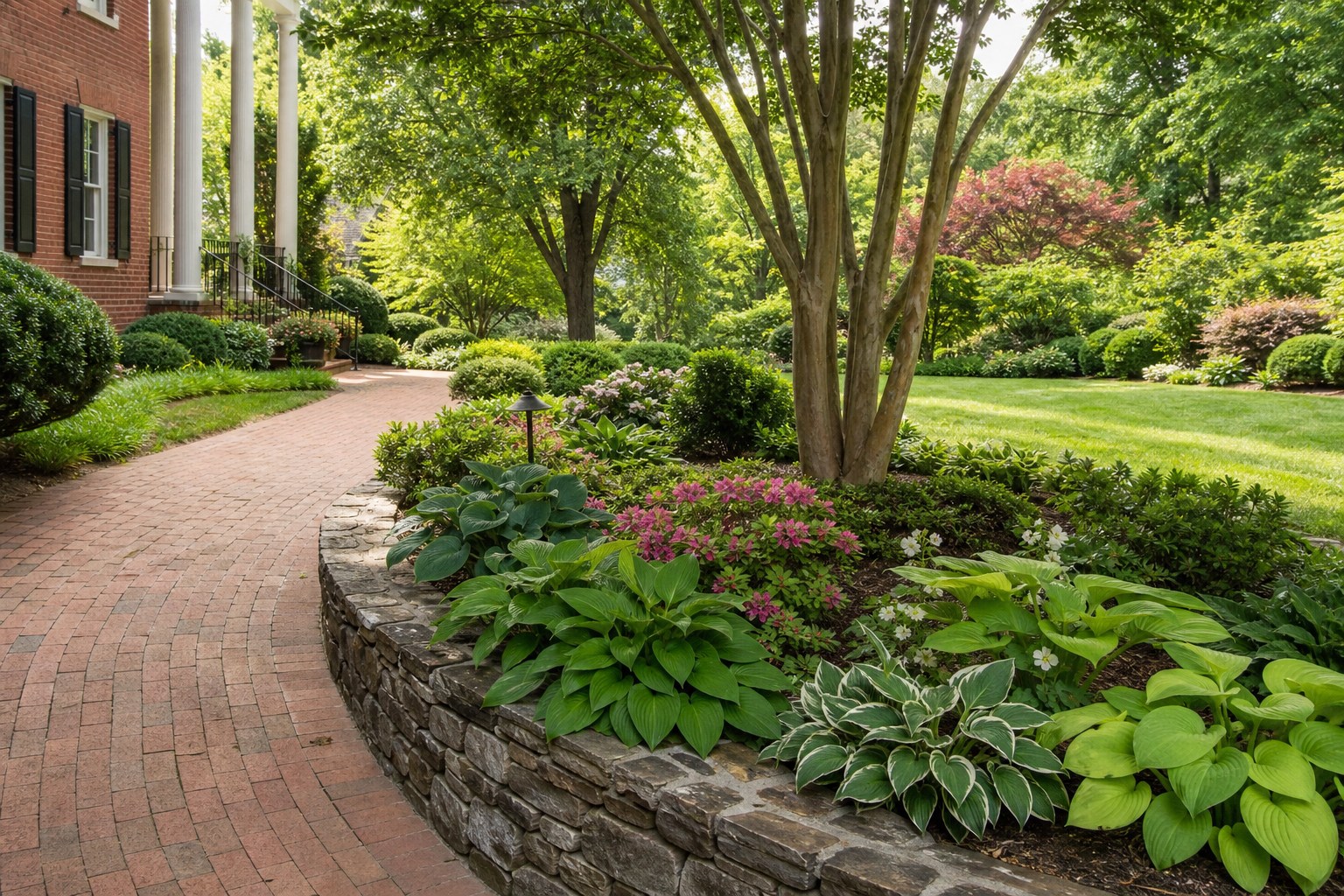 Designed residential garden with layered beds at a brick home in Charlotte, North Carolina